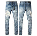 Amiri MX1 Distressed Logo Jeans – Light Blue